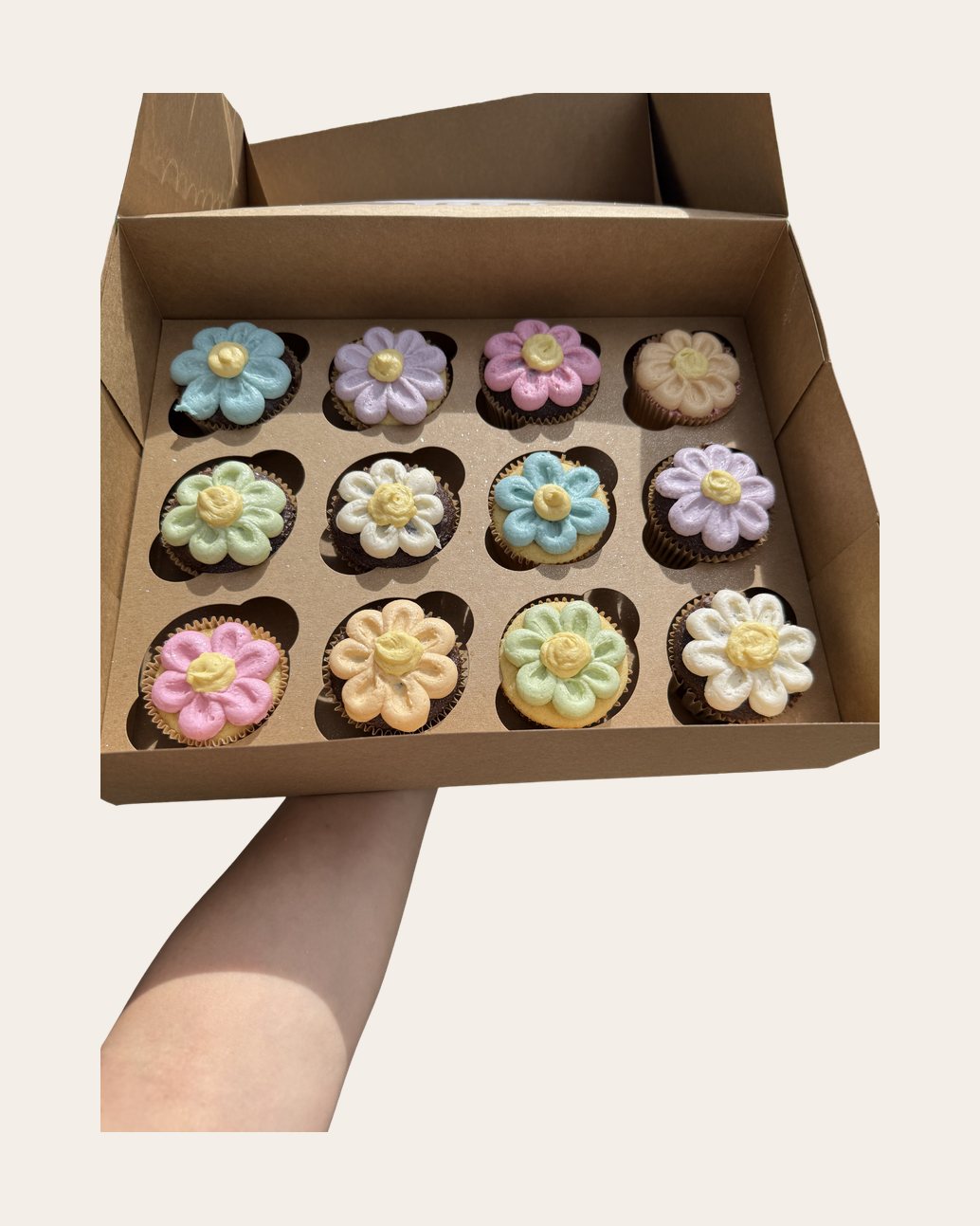 Box of pastel buttercream flower cupcakes